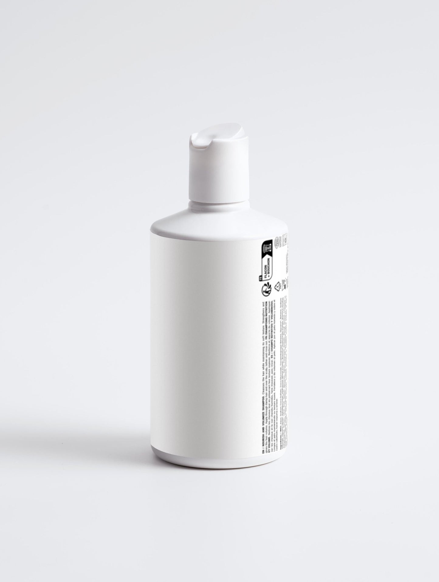 Bottle of Nourish and Volumize Shampoo on white background