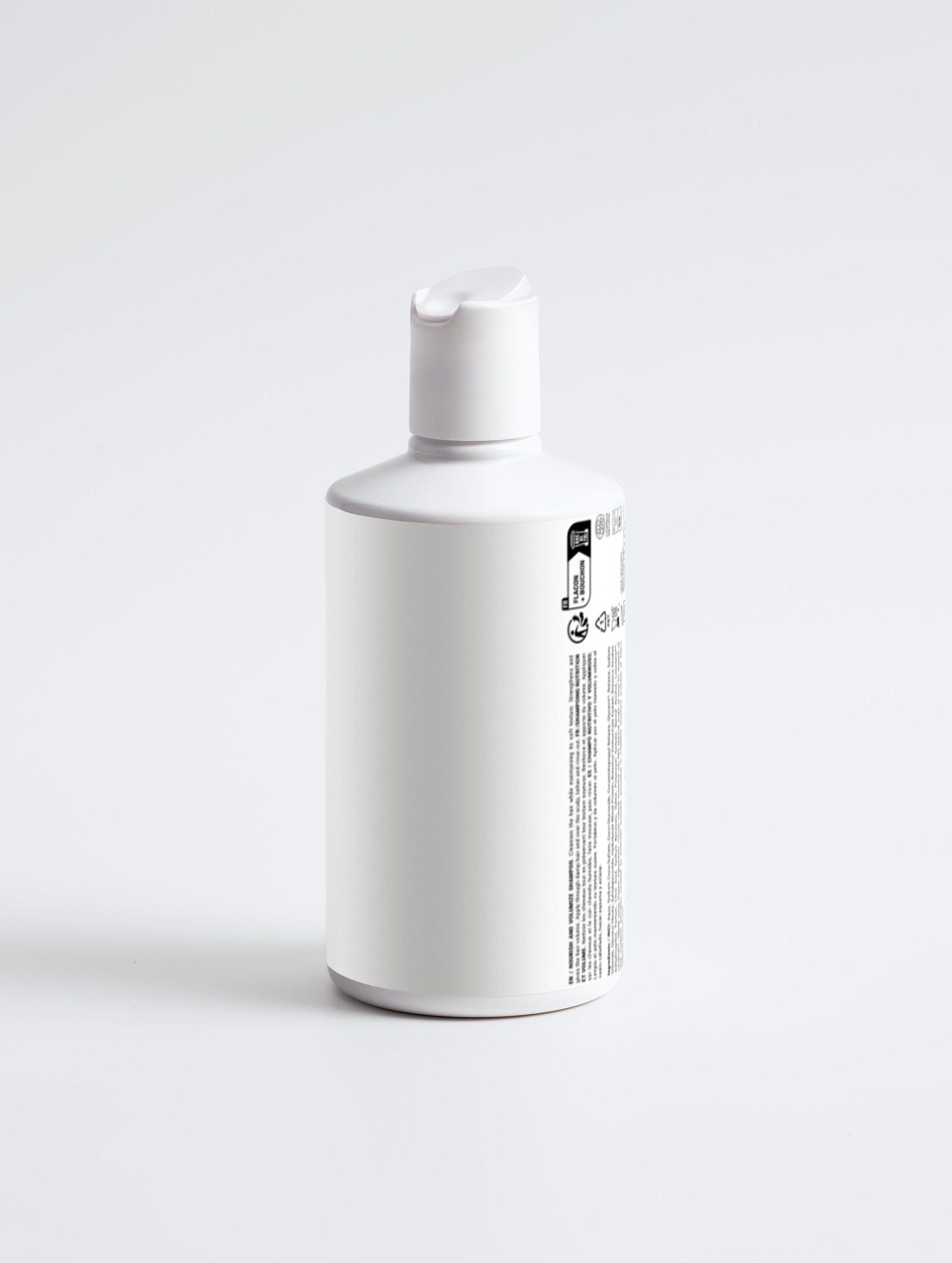 Bottle of Nourish and Volumize Shampoo on white background